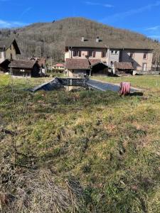 a large house in a field with a house at gite du Breuchin trois in La Longine +3 photos