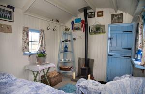 a room with a bedroom with a bed and a fireplace at Mollies Hut in Frome