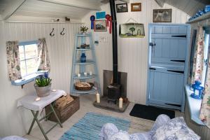 a living room with a fireplace in a tiny house at Mollies Hut in Frome