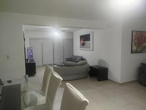 a living room with a couch and chairs at Cancun in Cancún