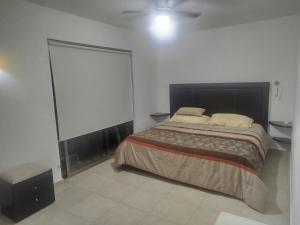 a bedroom with a bed and a large screen at Cancun in Cancún