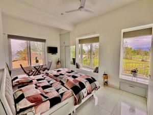 a bedroom with a large bed and two windows at Mayur Home Stay, Morni Hills in Morni +55 photos