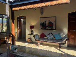 a living room with a couch with pillows on it at Samudrawasa Luxury Colonial Villa & Beach House in Ambalangoda