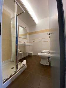 a bathroom with a toilet and a glass shower at Mare Nostrum Petit Hôtel in Pozzallo +115 photos