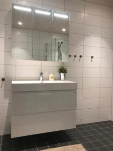 a white bathroom with a sink and a mirror at Trysilmountainlodge in Hovi