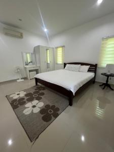 a bedroom with a large bed and a rug at BN Villa Walk to Bangtao Beach Near Markets in Phuket