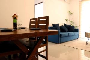 a living room with a table and a blue couch at Colombo City Apartment in Colombo