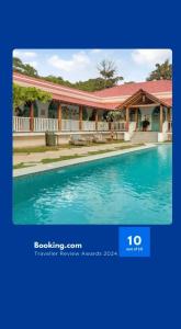a picture of a house with a swimming pool at EKOSTAY - Blue Tiffany Villa in Nerul