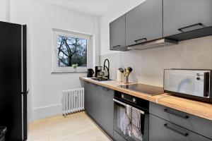 a kitchen with a sink and a stove top oven at Lünen Living Apartment #12 in Lünen