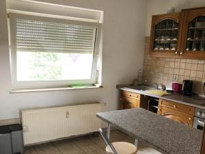 a kitchen with a window and a table in it at Monteurwohnung in Zuelpich in Zülpich