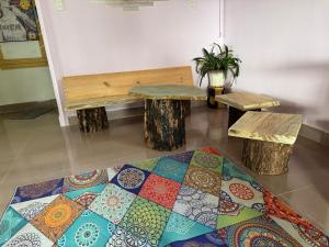 a room with two benches and a rug at Đưa Nhau Đi Trốn in Xuan An