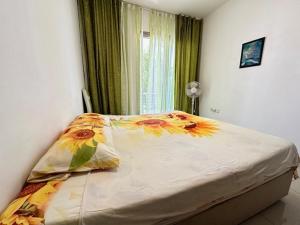 a bedroom with a large bed with a flower blanket at Tempo Sea Suits in Kérynia