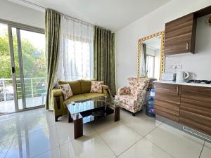 a living room with a couch and a chair and a table at Tempo Sea Suits in Kérynia