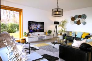 a living room with a couch and a tv at Montreux Holiday Home in Montreux