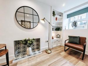 a living room with a fireplace and a mirror at 2-Bed Apartment - For Contractors & Business Travellers - Long Stays Welcome in Exeter +32 photos