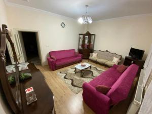 a living room with a purple couch and a table at Kapadokya Denizhan Villa in Ürgüp