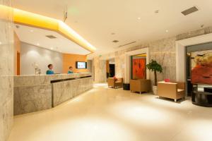 a lobby of a hotel with a reception counter at Jinjiang Inn Yanji Railway Station Municipal Government in Yanji