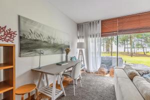 una sala de estar con una mesa y un sofá en Sunny Villa, en Tróia