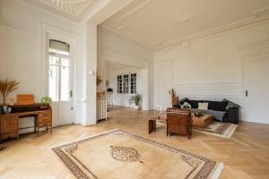 a large living room with a couch and a piano at Hôtel particulier - Le 119 in Valenciennes