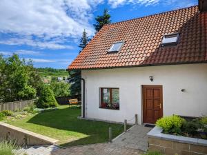a white house with a red roof at Guest House KRISTI in Tuchoměřice