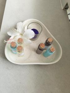 a white plate with a flower and candles on it at 1 bed peaceful studio Apartment near Colva beach in Benaulim