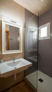a bathroom with a sink and a shower at Apartamentos Es Pou - Emar Hotels in Sant Ferran de Ses Roques