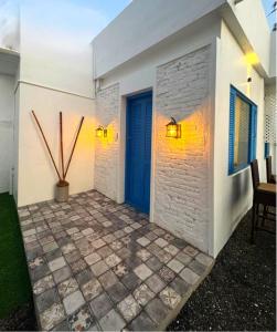 a house with a blue door and a patio at Casa Del Mar - Sea Facing Villa in Cochin