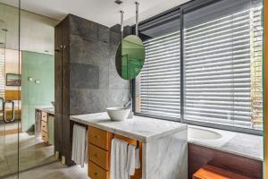 a bathroom with a sink and a tub and a mirror at Summer Villa in Grândola +25 photos
