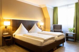 Postel nebo postele na pokoji v ubytování Hotel Aulmann