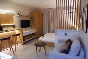 a living room with a couch and a bed at Lapu2x Studio apartments feels home in Lo-oc