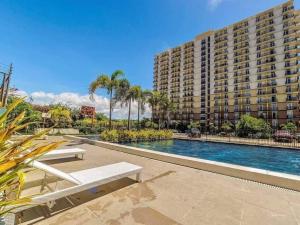 a large apartment building with a swimming pool and a building at Lapu2x Studio apartments feels home in Lo-oc