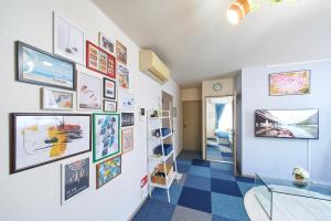 a hallway with a wall with pictures on it at AO201 - 2F Tokyo Stay Hotel Direct Train to Narita & Asakusa in Tokyo