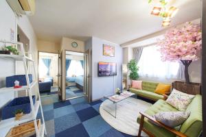 a living room with a couch and a table at AO201 - 2F Tokyo Stay Hotel Direct Train to Narita & Asakusa in Tokyo