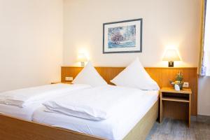 Postel nebo postele na pokoji v ubytování Hotel Aulmann