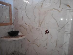 a white marble bathroom with a sink and a mirror at Dika Homestay in Sidemen +59 photos