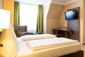 Postel nebo postele na pokoji v ubytování Hotel Aulmann
