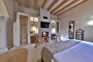a bedroom with a bed and a fireplace at Simurg Cave House in Ürgüp +161 photos