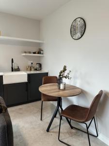 a kitchen with a table and two chairs and a sink at The Nook in Plett in Plettenberg Bay +14 photos