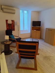 a living room with a couch and a table at Appartement au centre de Bourbon in Bourbon-lʼArchambault