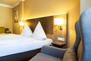 Postel nebo postele na pokoji v ubytování Hotel Aulmann