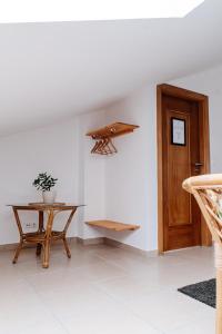 a room with a table and a wooden door at Green House in Baleal