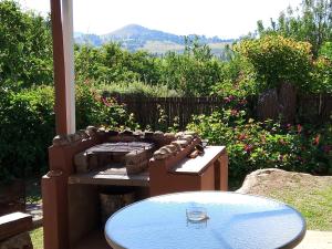 a patio with a table and a pool of water at Gentle Presence Cottage 2 - Garden Unit in Clarens