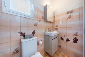 a bathroom with a toilet and a sink at Lotus Apartment 1 in Corfu +19 photos