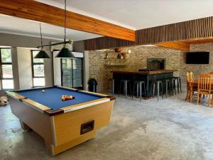 a living room with a pool table and a bar at Ukujabula in Groblersdal