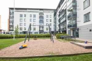 a playground in front of a building at Kotimaailma Two bedroom apartment with private sauna in Vaasa