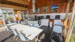 a kitchen and dining room with tables and chairs at Campinghytter ved Jotunheimen in Randsverk