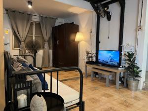 a living room with a laptop computer on a table at 3 bedrooms 2 bathroom's in Bang Su