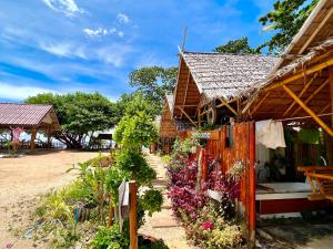 a house with flowers in front of it at Libong Luxury Beach in Trang