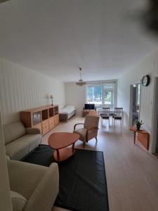 a living room with a couch and a table at Kotimaailma 1 bedroom apartment in city center in Vaasa