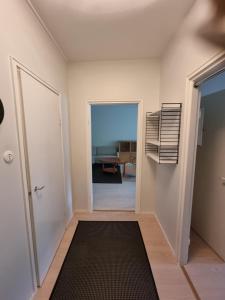 an empty hallway with a door and a room at Kotimaailma 1 bedroom apartment in city center in Vaasa